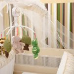 Berceau avec jouets suspendus et moustiquaire dans une chambre d'enfant